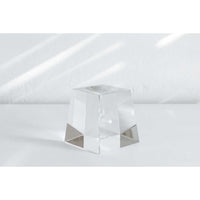 Transparent acrylic cube displayed on Mova Globe Crystal Base for elegant decor
