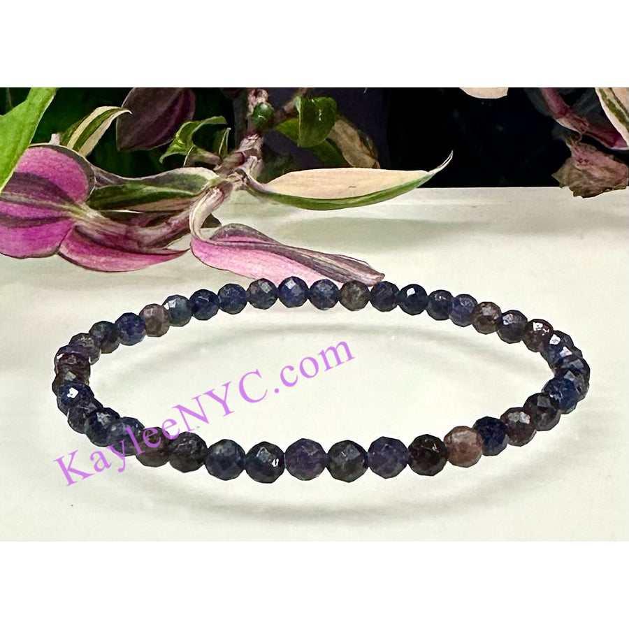 Dark blue faceted Sapphire bead bracelet on a crystal bracelet display