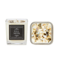 Small glass candle with white and black label from New Moon crystal candles collection