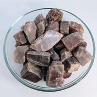 Peach Moonstone rough slices in a bowl, ideal for spiritual teachers and healing