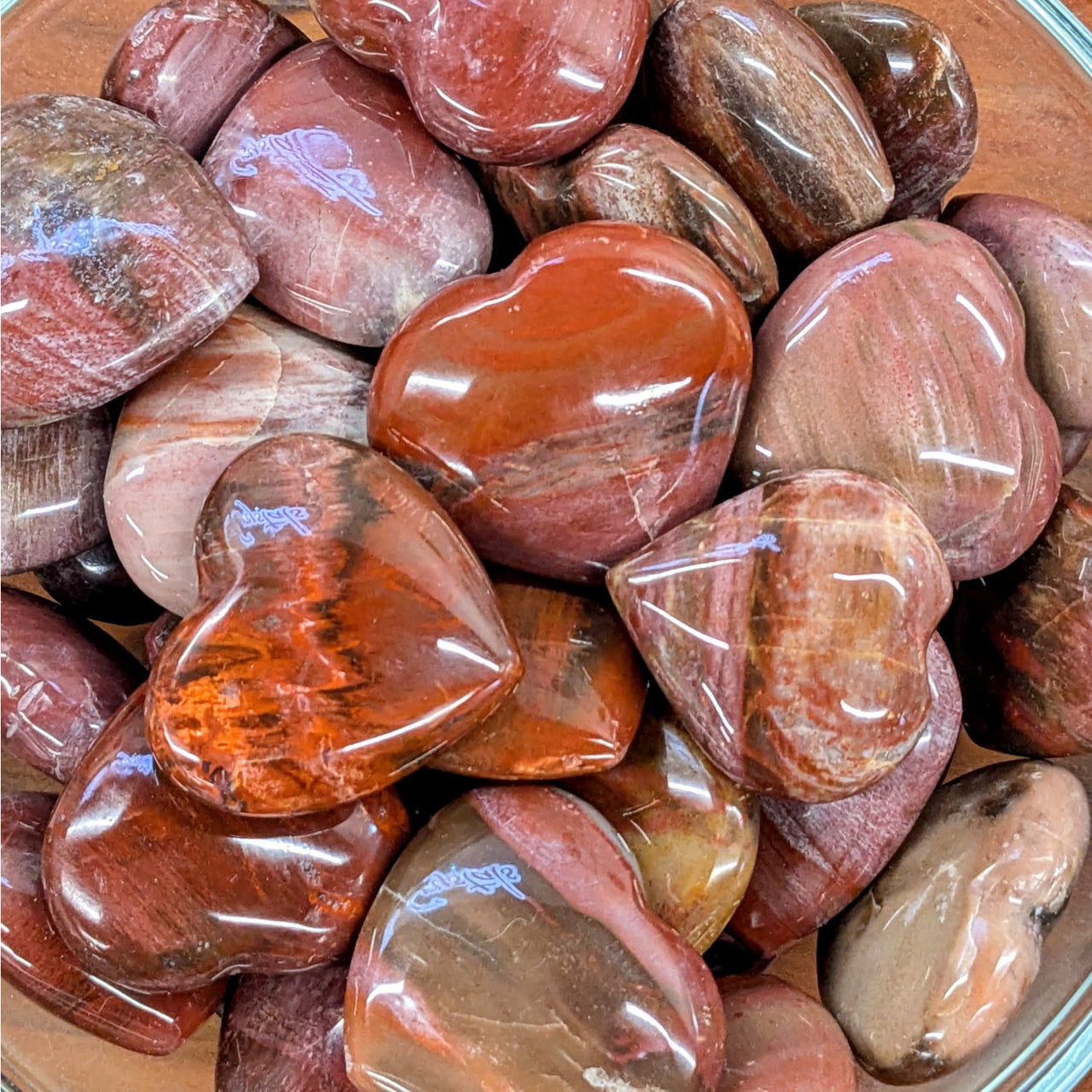 Polished red and brown petrified wood heart-shaped stones for reward notifications display