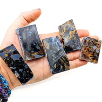 Five dark Pietersite unpolished slab pieces showcasing unique blue and orange-brown patterns