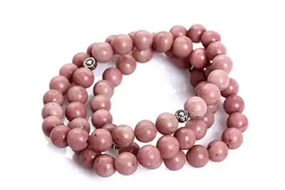 Pink beaded necklace arranged in a curved shape.