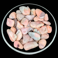 Bowl of pink petalite and cleavelandite tumbled stone for decorative use