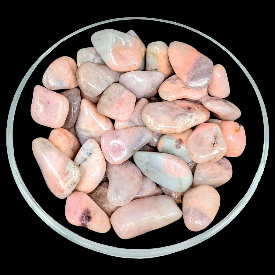 Bowl of pink petalite and cleavelandite tumbled stone for decorative use