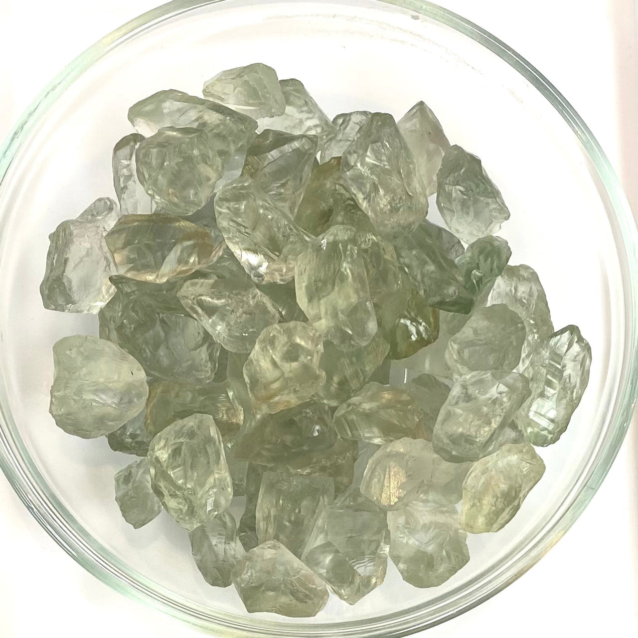 Clear green amethyst rough rocks showcasing translucent green-gray hues
