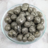 Silver foiled chocolates in a bowl displayed with Pyrite Round Tumble Stone #LV2260
