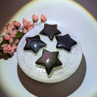 Four rainbow obsidian star crystals carved from volcanic molten lava natural glass