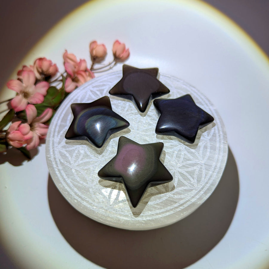 Four rainbow obsidian star crystals carved from volcanic molten lava natural glass