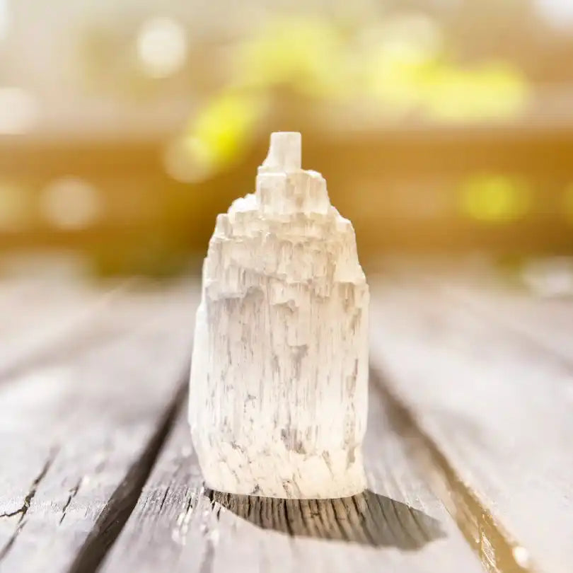 Raw selenite crystal with a natural tower-like formation.
