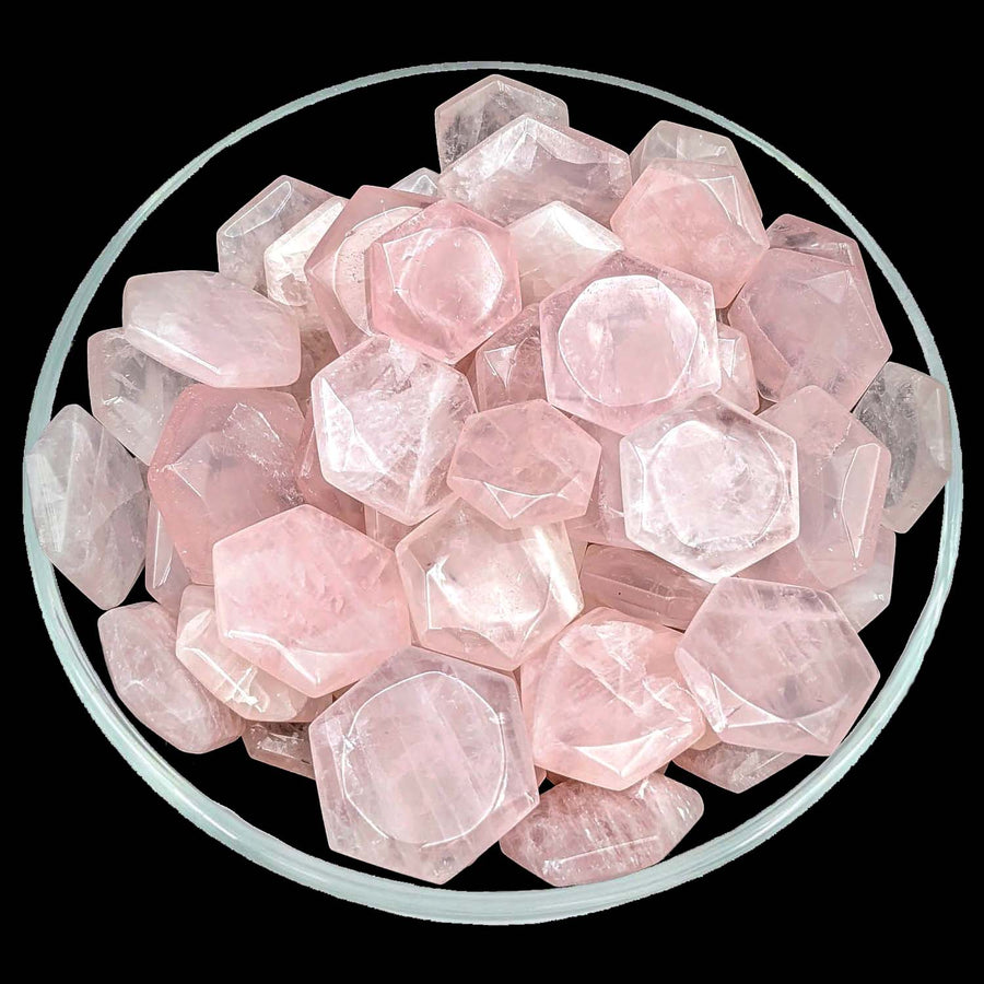 Bowl filled with rose quartz gems from the Rose Quartz Gem Cut Hexagon Star Carving SK5982