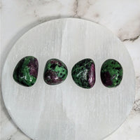 Three green and purple tumbled stones on white marble plate - Ruby Zoisite .9-1’ #LV4057