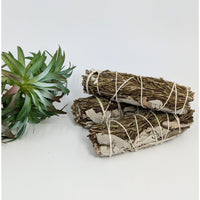 Bundled sage and rosemary smudge sticks for cleansing and spiritual rituals