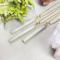 Three elegant white selenite geode pendants with gold edges on 18’’ chains