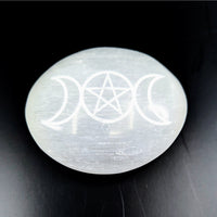 Polished white Selenite palm stone with engraved triple moons and pentagram symbol