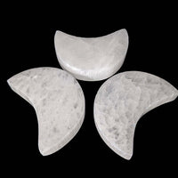 Three crescent-shaped Selenite Mini Moon Carvings arranged in a triangle