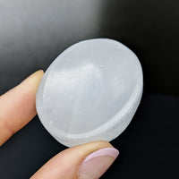 Person holding a Selenite Mini Thumb Stone 1.7’ #SK9200 for crystal healing and meditation