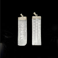 White crystal pendants with etched moon phases and Flower of Life pattern on silver bails