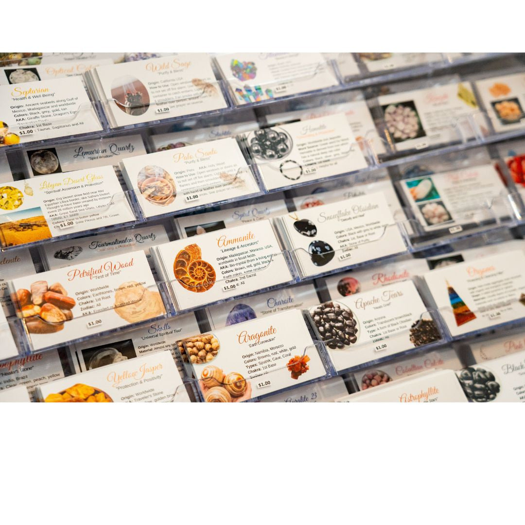 Clear plastic display cases holding a set of 210 double sided crystal zodiac chakra usage information cards in bulk