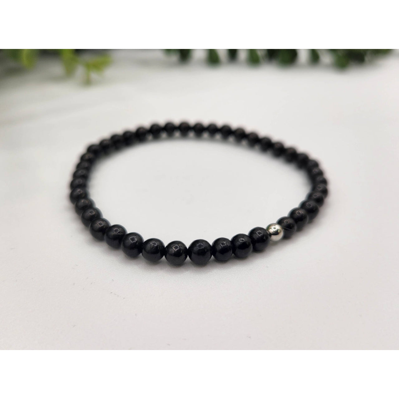 Black beaded Shungite bracelet with a silver bead for EMF protection and control
