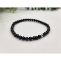 Black beaded Shungite bracelet with a silver bead for EMF protection and control