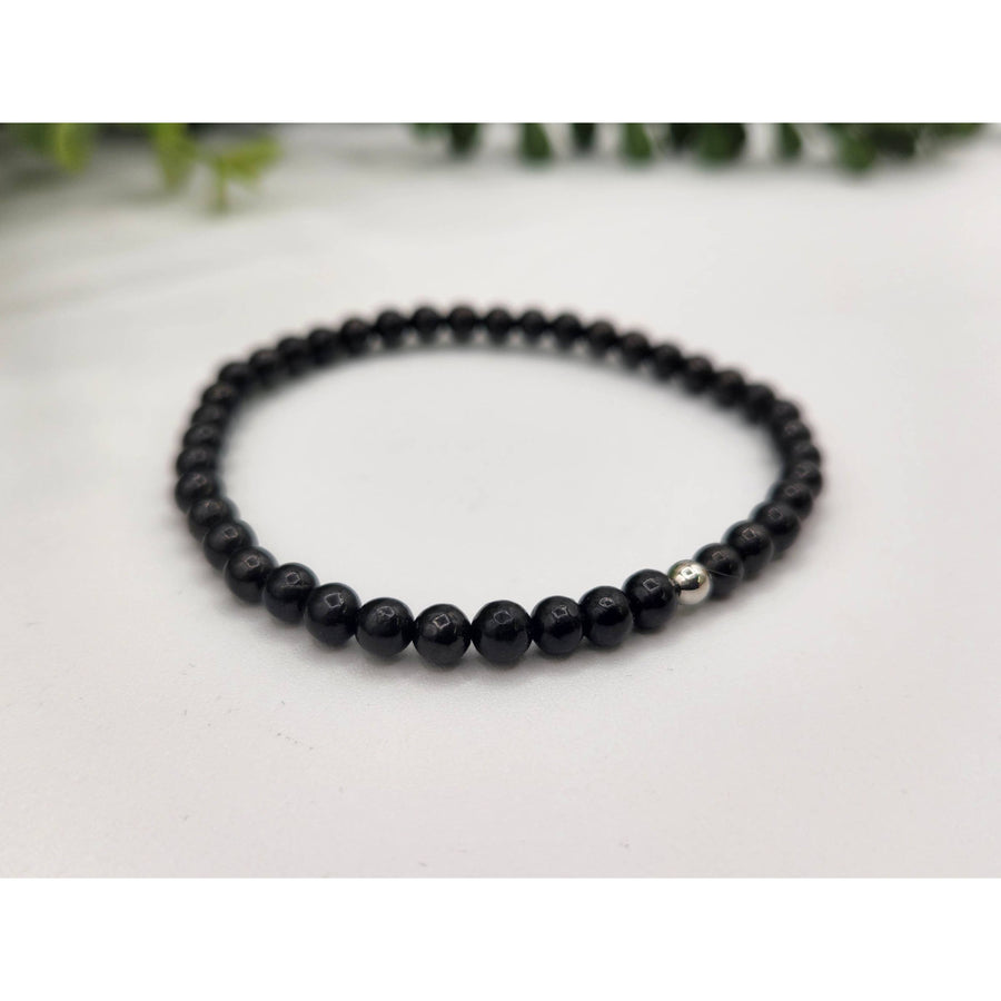 Black beaded Shungite bracelet with a silver bead for EMF protection and control