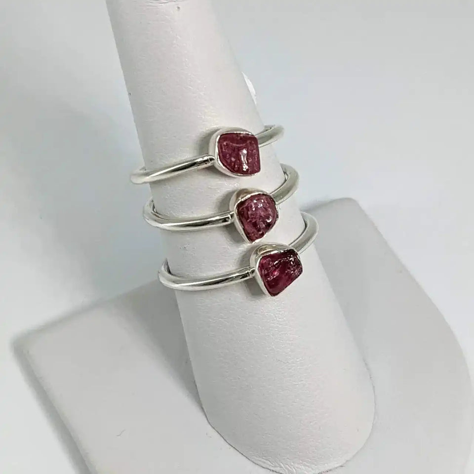 Sterling silver ring featuring three rough pink tourmaline stones in a spiral design.