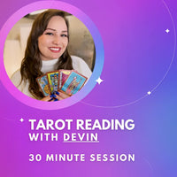 A woman holding a card reading ’tared with devi 30 minute session’ - Tarot Reading With Devin