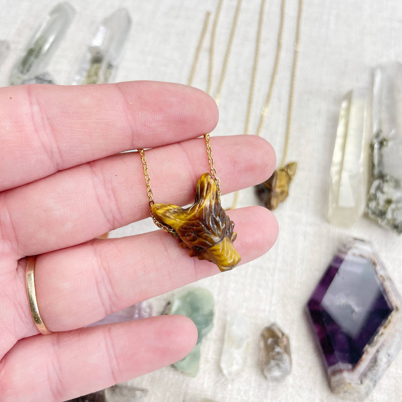 Golden tiger head pendant necklace with polished amber-brown stone finish