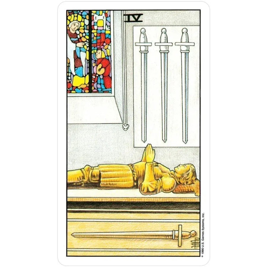 A drawing of a person laying on a table from the Universal Waite Tarot Deck in a Tin
