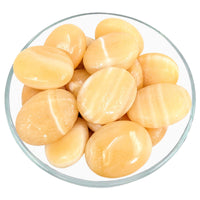 Peeled potatoes in bowl beside Yellow Aragonite Pillow Palm Stone LV2268